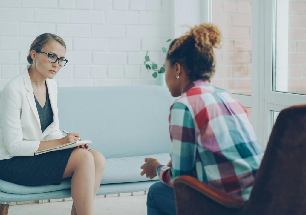 A therapist listens attentively during a private counseling session.